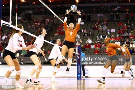 OMAHA, NE - APRIL 22: Jhenna Gabriel #2 of the Texas Longhorns hits a set against the Wisconsin Badgers during the Division I Womens Volleyball Semifinals held at the Chi Health Center on April 22, 2021 in Omaha, Nebraska. (Photo by Jamie Schwaberow/NCAA Photos via Getty Images)